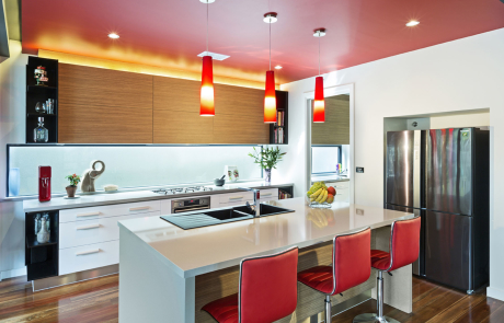 red and white themed kitchen with island and breakfast bar