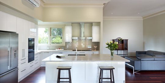 open plan white kitchen attached to lounge
