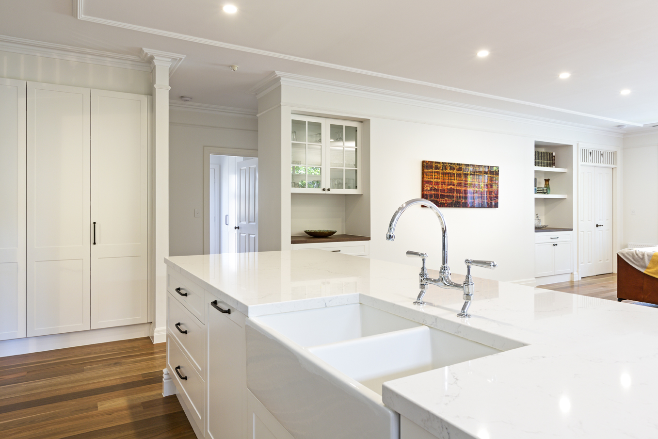 spacious white open plan kitchen with twin sink