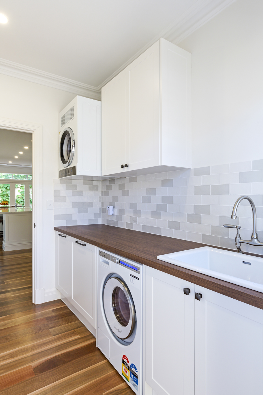 laundry with wooden countertop and washing machine and laundry